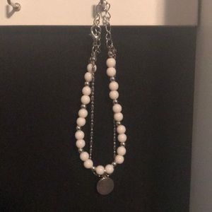 White and silver bracelet with circular pendant